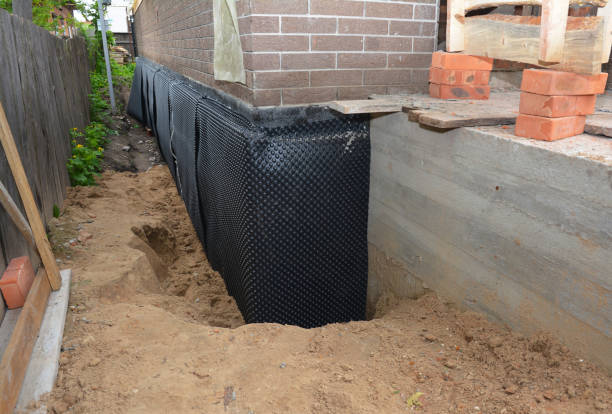 Happy homeowners after waterproofing job in Stewart